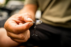 Screw-lock bait keeper secures soft plastics for durable, stable rigs.