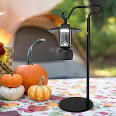 Adjustable shepherd's hook lantern stand supports wind chimes securely outdoors.