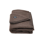 Arcturus Military Wool Blanket on campsite at dusk, offering generous warmth for two.