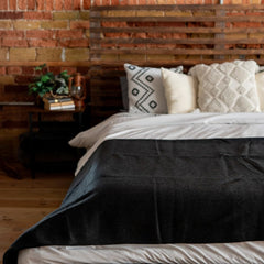 Arcturus Military Wool Blanket on couch, cozy warmth for lounging.