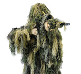Arcturus Warrior ghillie suit jacket blends with vegetation in woodland terrain.