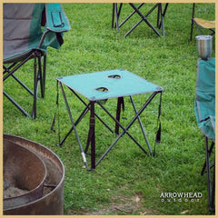ARROWHEAD OUTDOOR folding table with two cup holders keeps drinks within reach.