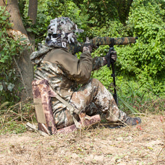 AUSCAMOTEK camouflage pattern helps concealment in woodland settings during outdoor activities.