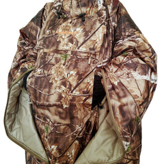 AUSCAMOTEK woodland camo hunting poncho blends into forest brush for concealment.