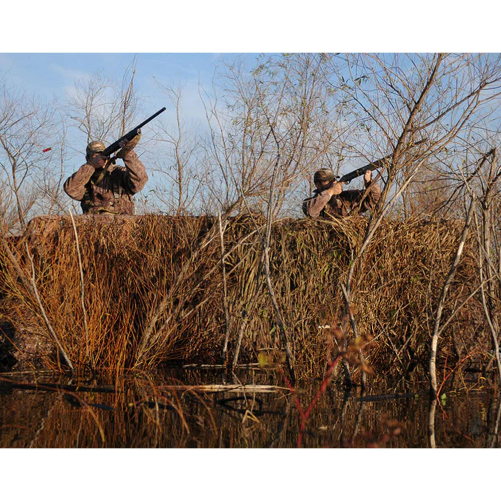 Avery RealGrass camouflage mats on a boat blind provide natural concealment.