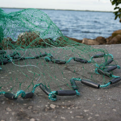 Close-up of 1-1/4 in square mesh on Bait Buster Mullet Cast Net with packaging
