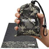 BEARZ Outdoor pocket blanket in camo folded for compact carry on hikes.