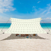 BEW Beach Tent UPF 50+ shade in use at the sunny shoreline.