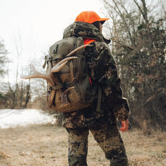 BOG Prevail Day Pack retractable bottle pocket in use with a 32 oz bottle