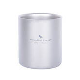 Boundless Voyage double-walled titanium cup shown with a pour, heat-protected grip on a campsite.