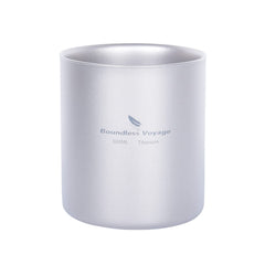 Boundless Voyage double-walled titanium cup shown with a pour, heat-protected grip on a campsite.