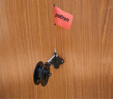 Brocraft ice fishing rattle reel wall mount installed on an ice shanty wall