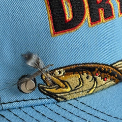 Side profile of Brown Trout Rising Magnet Hat showing blue wing