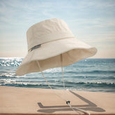 Beige bucket hat with adjustable chin strap for outdoor activities