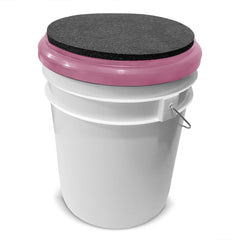 BUCKET PROS pink bucket lid seat with black pad close-up shows cushioned surface.