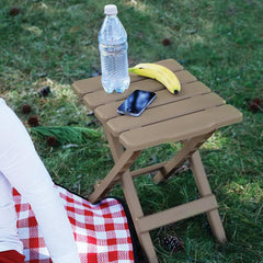 Folded Camco Adirondack table shows compact storage and portability.