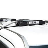 Catch Surf Surf Rack Single Black main view showing secure soft mounting for car transport.