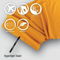 COCOON Hyperlight Towel Sunrise Small with strap for quick attachment to a bag.