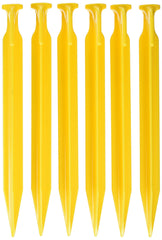 Coghlan's 9-inch ABS tent pegs anchored in soil for secure camping setup