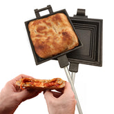 Coghlan's camp cooker in action toasts pies by campfire