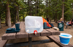 Coghlan's water container shown in a hiking pack during a trek