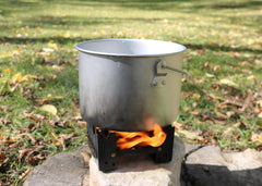 Coghlan's emergency stove with tablets demonstrating smokeless ignition for outdoor heat
