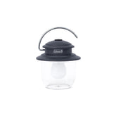Coleman Classic LED Lantern on a table providing bright campsite lighting up to 300 lumens.