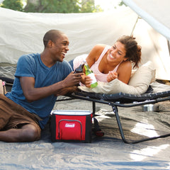 Coleman ComfortSmart cot with pull-out side tables for convenient on-site storage.