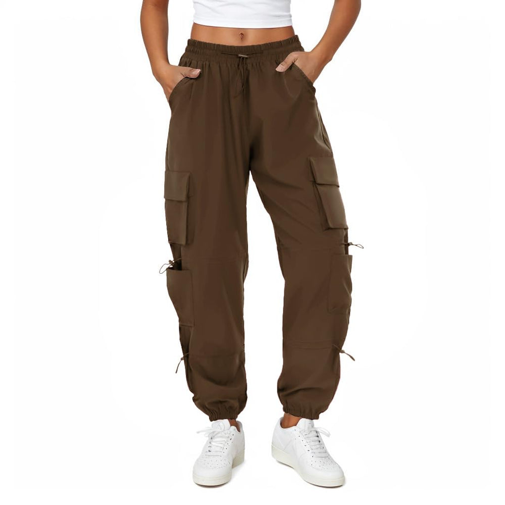 COPYLEAF women's parachute cargo pants show water-resistant coating for wet conditions.