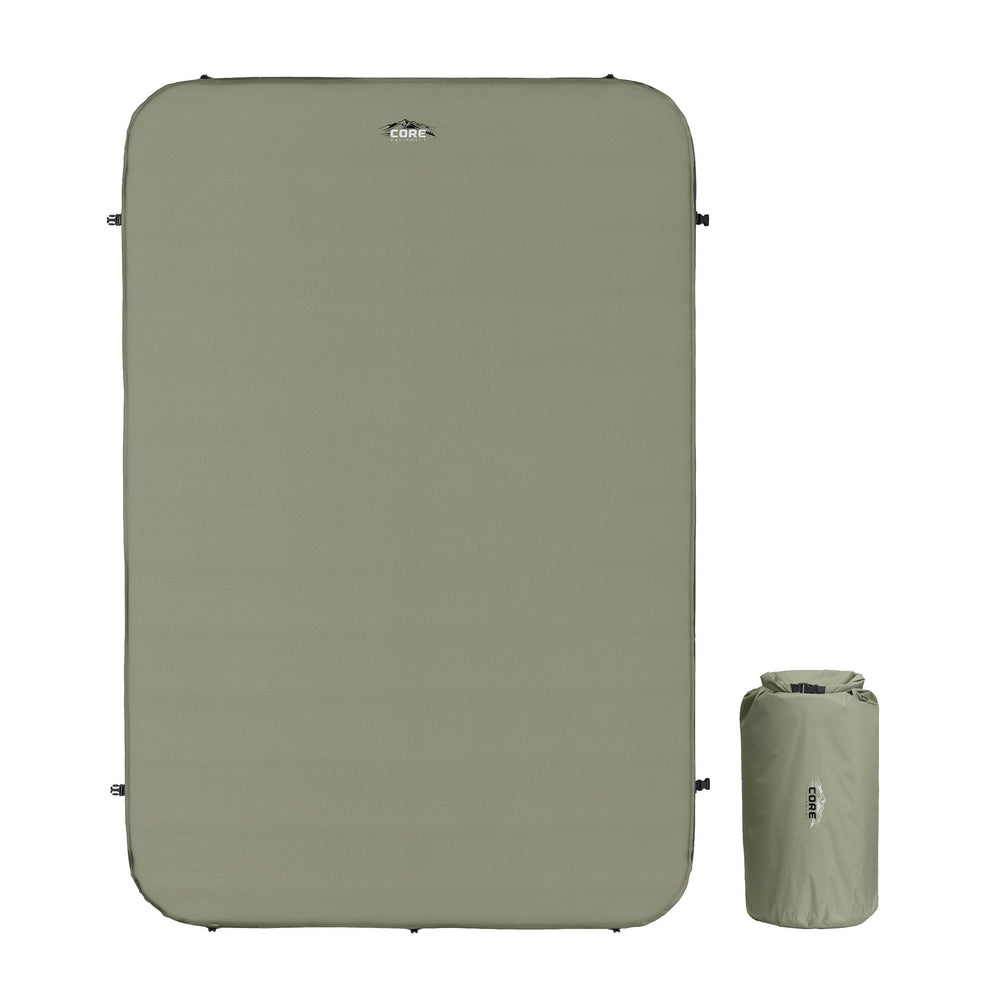 CORE Double Self Inflating Camping Bed unrolled and ready for comfort on a campsite.