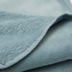Cuddledown plush fleece travel blanket unfolded to reveal velvety-soft texture.