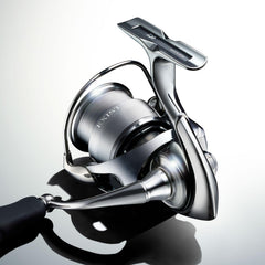 Daiwa Exist G LT spinning reel in black, side view highlighting ergonomic grip.