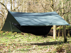 DD Hammocks Superlight Tarp being set up with a hammock for stormproof shelter