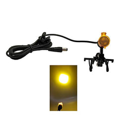 East clip clamp attached to a dental loupe for hands-free lighting during exams.