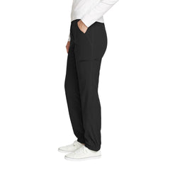 Eddie Bauer women's fleece-lined pants side pocket close-up showing secure zip storage in black.
