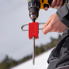 Universal compatibility showing the adapter holding various ice anchor designs including competitor anchors