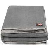 Ever Ready First Aid military wool blanket rolled for compact camping warmth and quick packing.