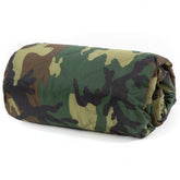 Farm Blue Jungle Camo blanket folded in its drawstring bag for easy camping setup.