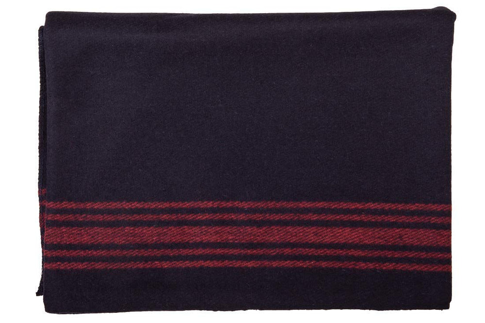 Farm Blue Wool Blanket folded in navy with red stripes, ready for quick warmth on the go.