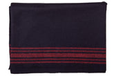 Farm Blue Wool Blanket folded in navy with red stripes, ready for quick warmth on the go.