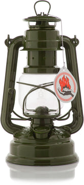 Feuerhand Baby Special 276 olive lantern on table, cozy outdoor lighting setup.