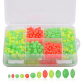Assorted luminous fishing beads in a clear storage box