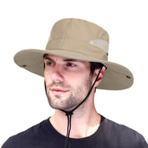 Foldable fishing hat in dark beige worn by model outdoors