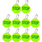 Fopytu STOP reflector pendant on backpack improves night visibility for safer commutes.