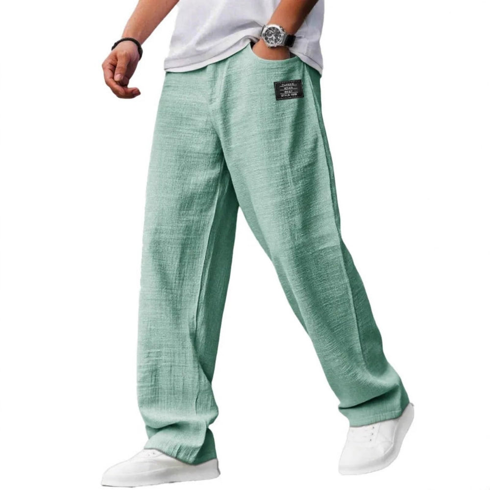 FQZWONG Mokaloha pants in black, front view highlighting deep pockets for essentials.