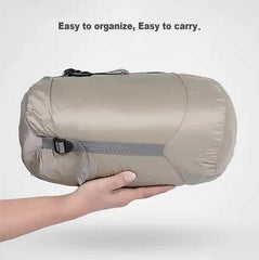 Gaorui ultralight poncho folded beside the storage bag for easy packing.