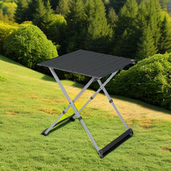 GCI Outdoor Compact Camp Table 25 folded with carry handle for easy storage.
