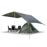 Geertop large hammock rain fly shelter spread over campsite offering expansive coverage for tents and hammocks