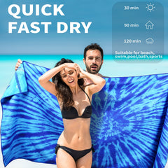 Gomust 71x32 oversized towel used as a beach mat on sand.