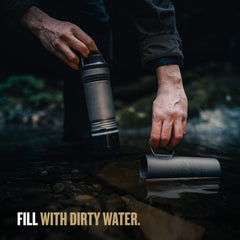 GRAYL UltraPress Titanium bottle filled from a river for on-the-go hydration